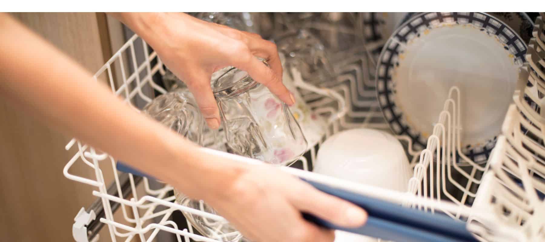 woman doing dishes at at home with soft water