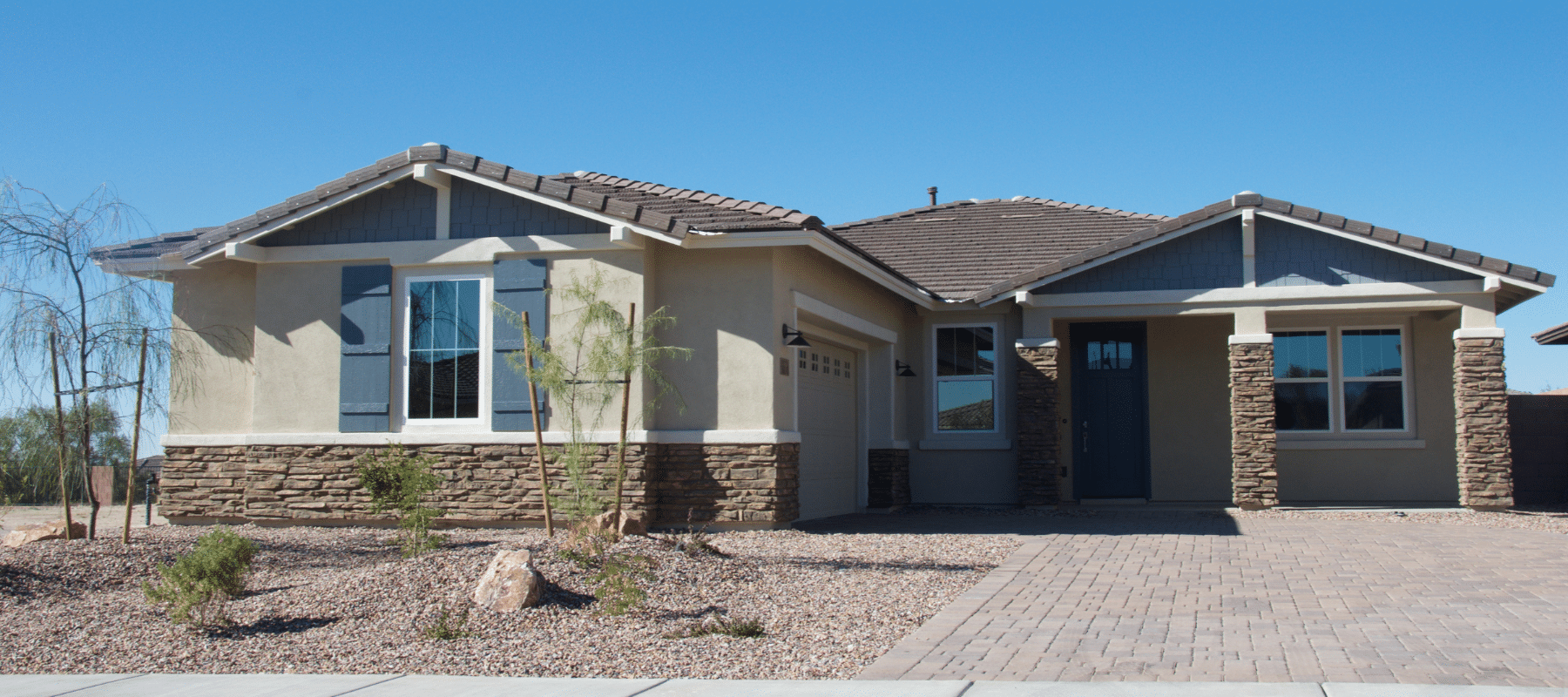 Modern single-story suburban home with a desert landscape design